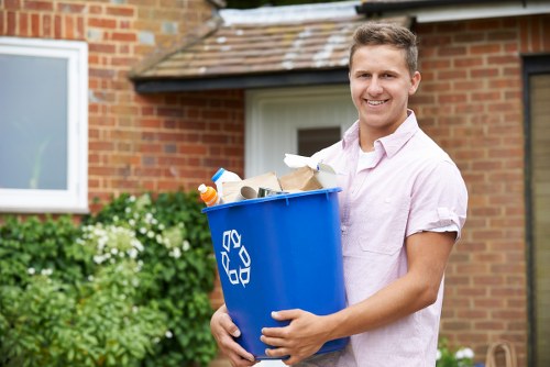 Worker managing rubbish removal with careful lifting and clear access
